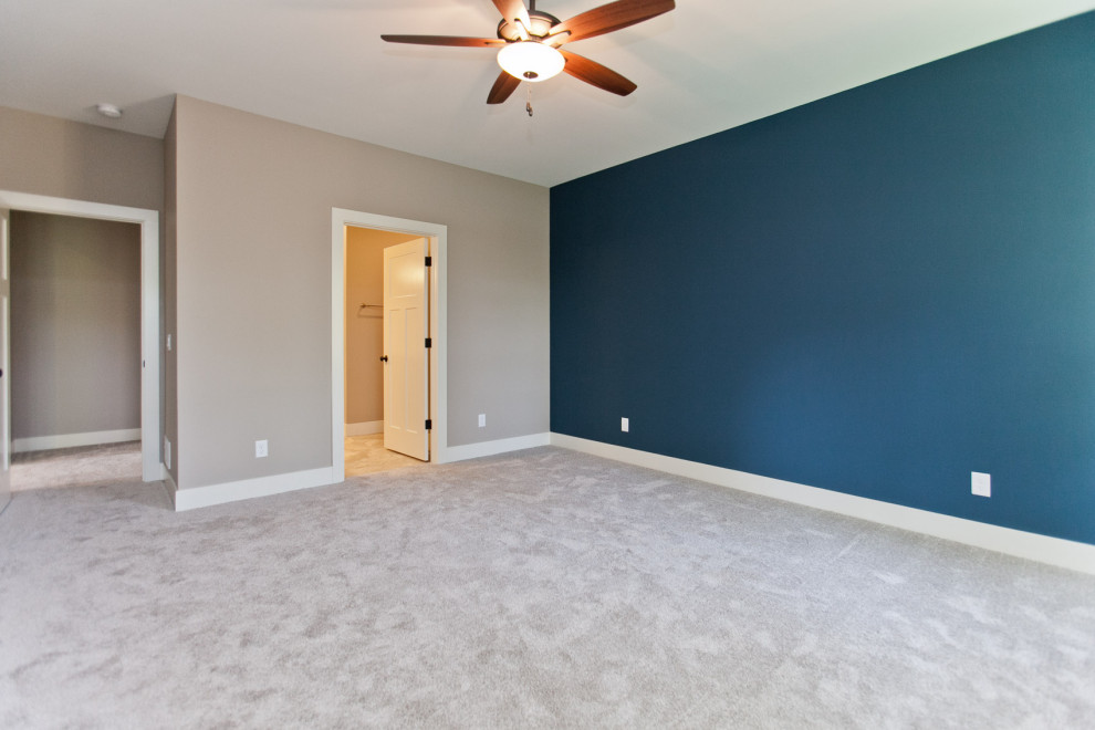 This is an example of a classic master bedroom in Cedar Rapids with carpet.