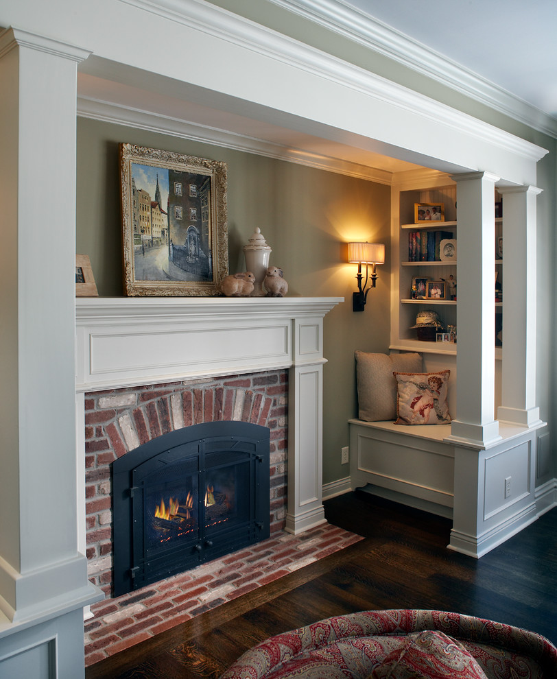 Inspiration for a traditional living room in Minneapolis with green walls, dark hardwood floors, a standard fireplace and a brick fireplace surround.