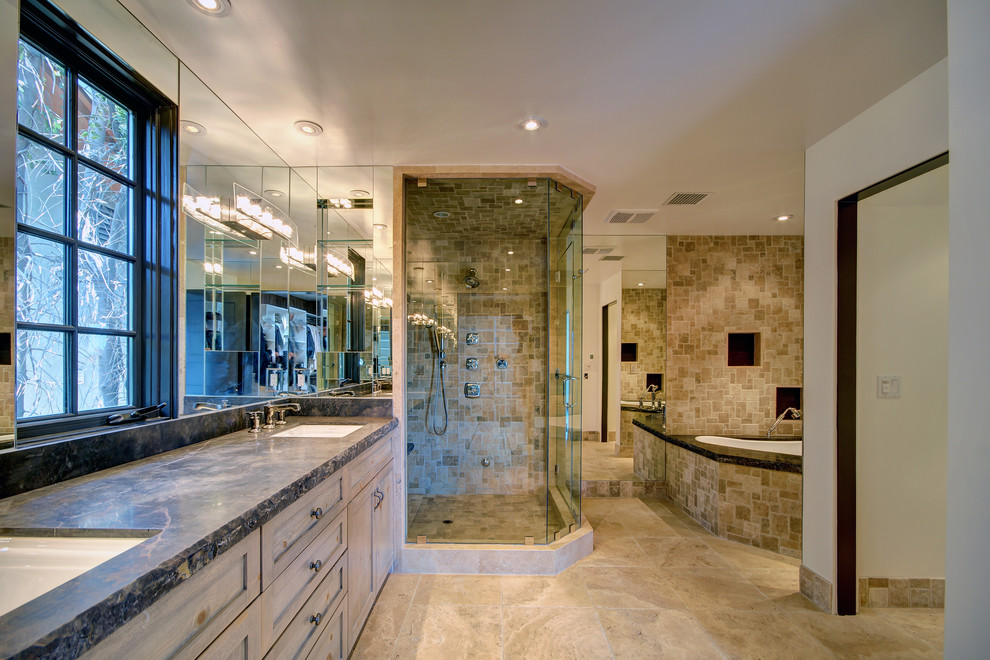 This is an example of an expansive traditional master bathroom in Los Angeles with recessed-panel cabinets, distressed cabinets, a hot tub, an alcove shower, beige tile, stone tile, beige walls, travertine floors, an undermount sink and onyx benchtops.