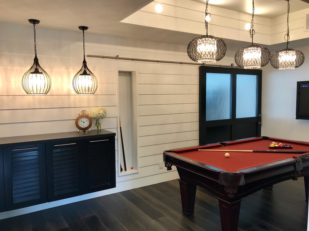 Mid-sized country enclosed family room in Los Angeles with grey walls, dark hardwood floors, no fireplace and black floor.