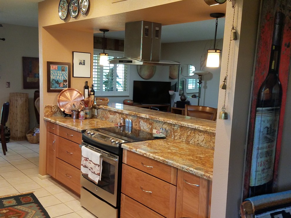 Kitchen - large transitional galley ceramic tile kitchen idea in Phoenix with a double-bowl sink, flat-panel cabinets, medium tone wood cabinets, granite countertops, stainless steel appliances and an island