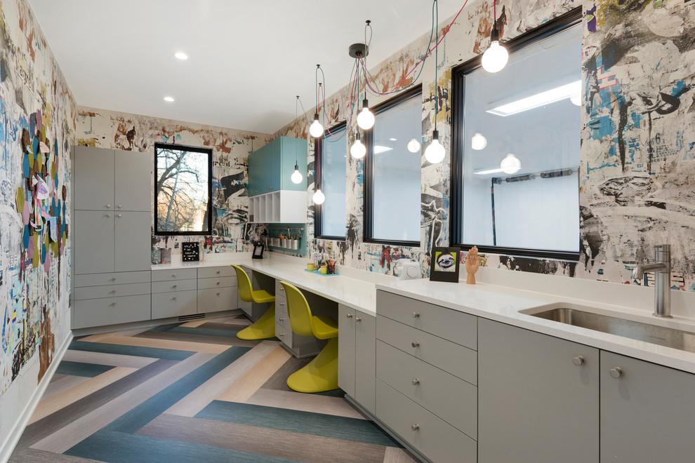 Craft room - large contemporary built-in desk multicolored floor and medium tone wood floor craft room idea in Minneapolis with multicolored walls