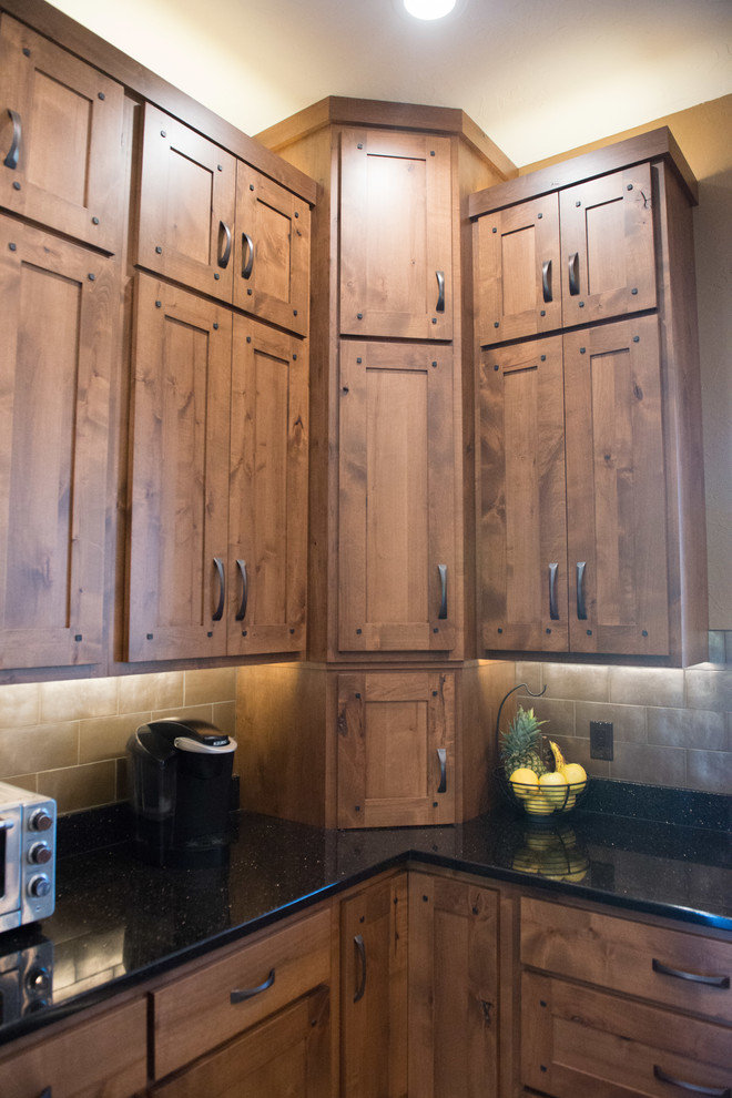 Huge mountain style u-shaped medium tone wood floor home design photo in Chicago with a double-bowl sink, shaker cabinets, medium tone wood cabinets, granite countertops, metallic backsplash, stainless steel appliances and two islands