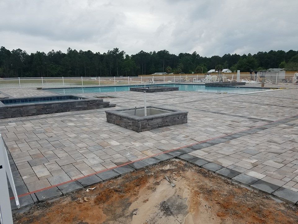 Inspiration for a large transitional backyard stone and custom-shaped natural hot tub remodel in Miami