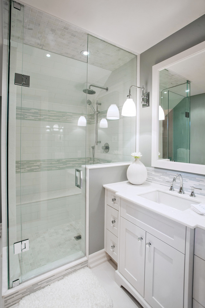 Inspiration for a small transitional bathroom in Toronto with an undermount sink, shaker cabinets, white cabinets, marble benchtops, a two-piece toilet, white tile, porcelain tile, blue walls, porcelain floors and an alcove shower.