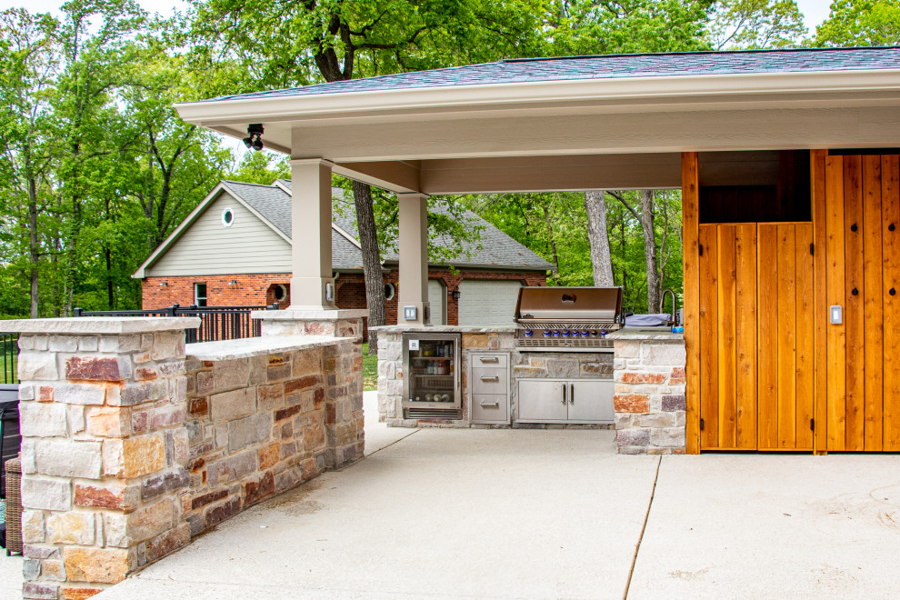 Covered Patio with an Outdoor Kitchen area and Fireplace Area Patio