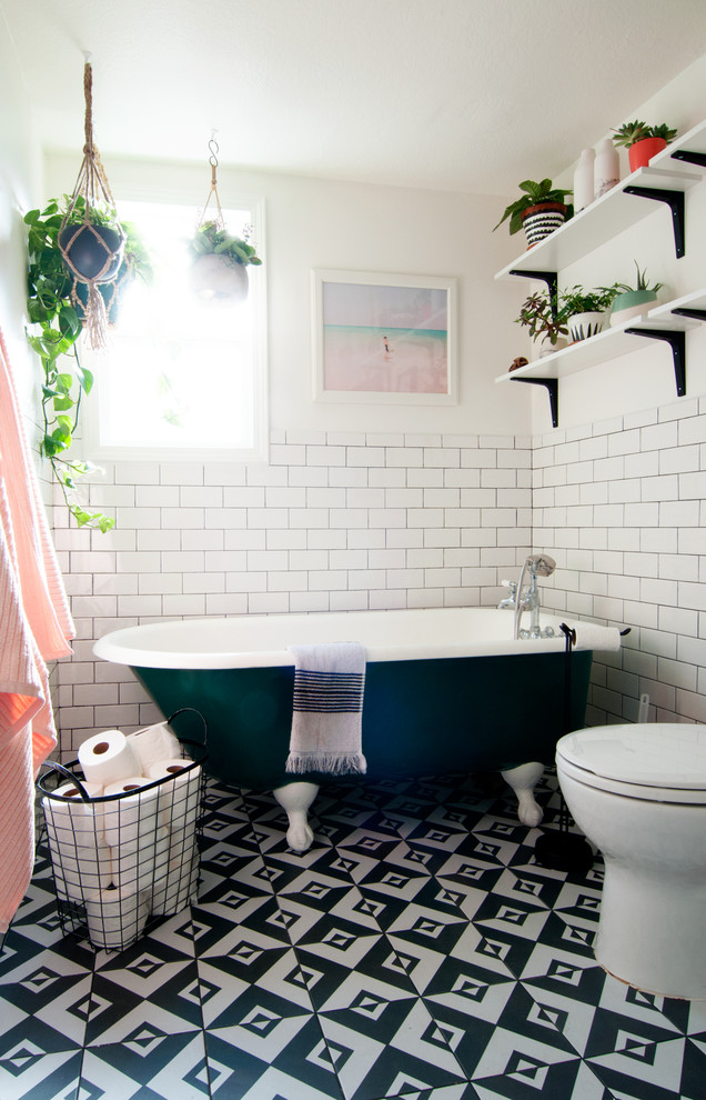 Design ideas for an eclectic master bathroom in Los Angeles with a claw-foot tub, subway tile, white walls, ceramic floors and black and white tile.