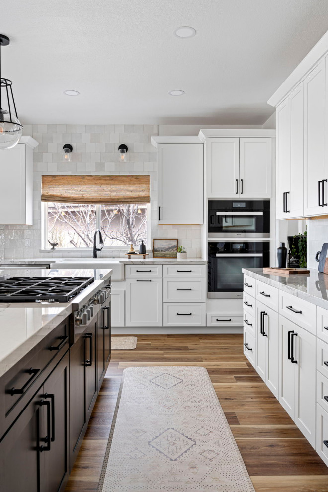 Kitchen - transitional vinyl floor and brown floor kitchen idea with a farmhouse sink, shaker cabinets, white cabinets, quartzite countertops, white backsplash and stainless steel appliances