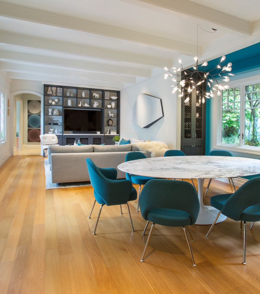This is an example of a contemporary open plan dining in Sacramento with white walls, medium hardwood floors, no fireplace and brown floor.