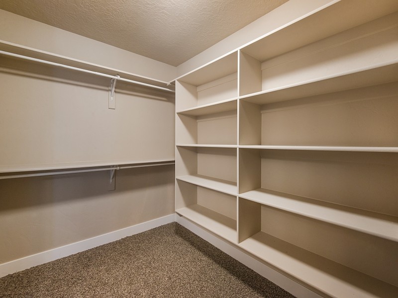 Inspiration for a large arts and crafts storage and wardrobe in Salt Lake City with carpet.