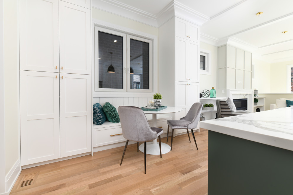 Design ideas for a large classic open plan kitchen in Chicago with shaker cabinets, white cabinets, white splashback, an island and white worktops.