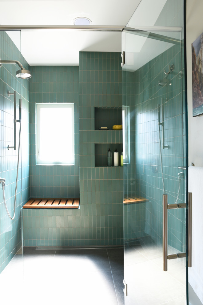 Photo of a mid-sized modern master bathroom in Indianapolis with flat-panel cabinets, brown cabinets, a curbless shower, a two-piece toilet, green tile, ceramic tile, beige walls, porcelain floors, a trough sink, solid surface benchtops, brown floor, a hinged shower door, white benchtops, a shower seat, a double vanity and a built-in vanity.