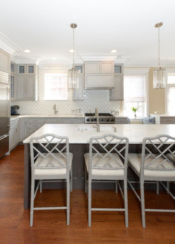 Eat-in kitchen - mid-sized transitional l-shaped medium tone wood floor eat-in kitchen idea in Chicago with recessed-panel cabinets, gray cabinets, multicolored backsplash, an island, an undermount sink, quartzite countertops, mosaic tile backsplash and stainless steel appliances