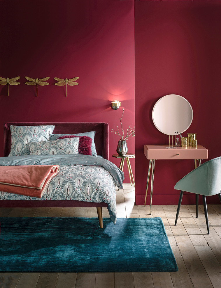 Inspiration for a contemporary bedroom in Moscow with light hardwood floors, pink walls and no fireplace.