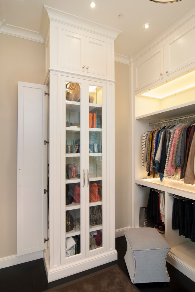 Photo of a mid-sized traditional gender-neutral dressing room in San Francisco with recessed-panel cabinets, white cabinets and dark hardwood floors.