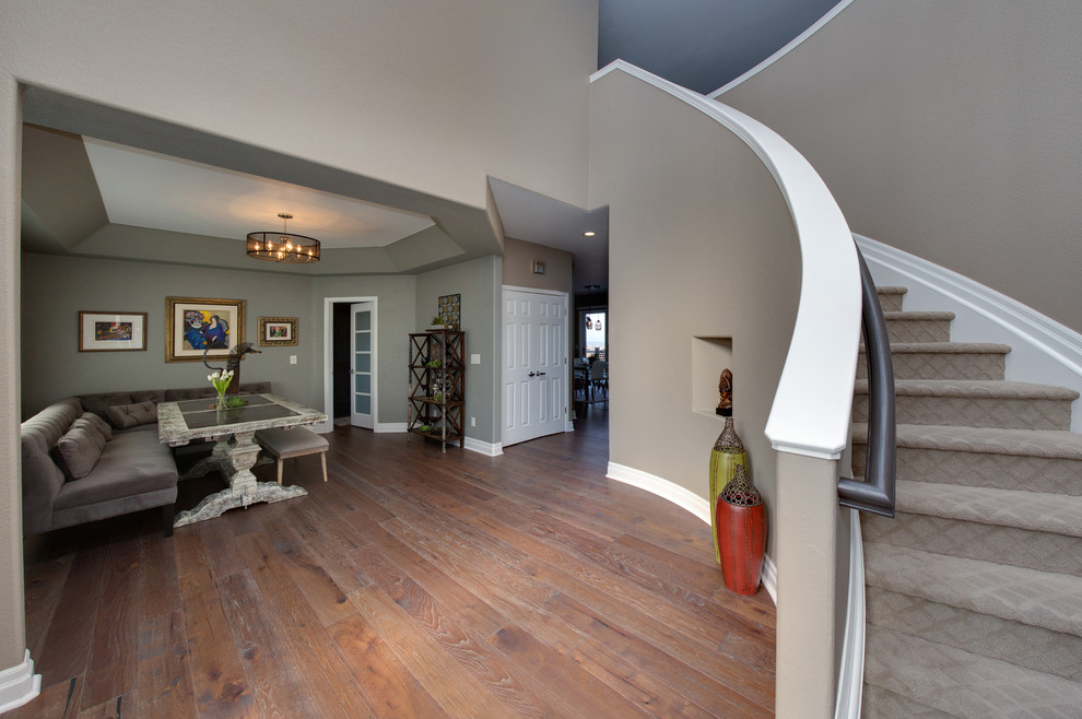 Inspiration for a huge transitional medium tone wood floor foyer remodel in Denver with beige walls and a brown front door