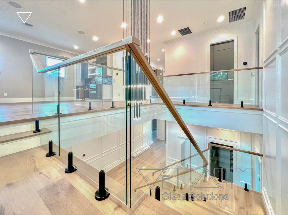 Photo of a large modern straight staircase in Orange County with metal risers and metal railing.