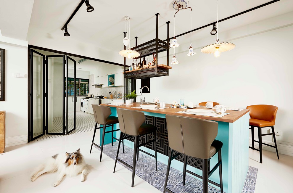 Inspiration for an eclectic dining room in Singapore with white walls and beige floor.