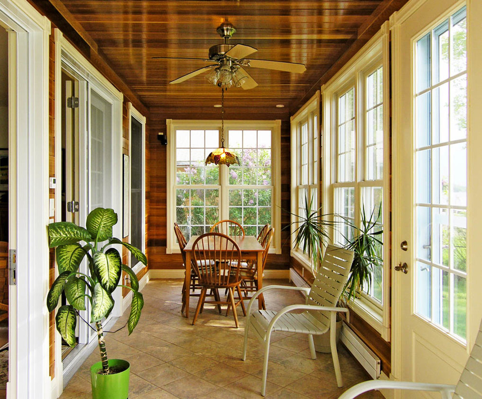 This is an example of a small traditional sunroom in Burlington with travertine floors and a standard ceiling.