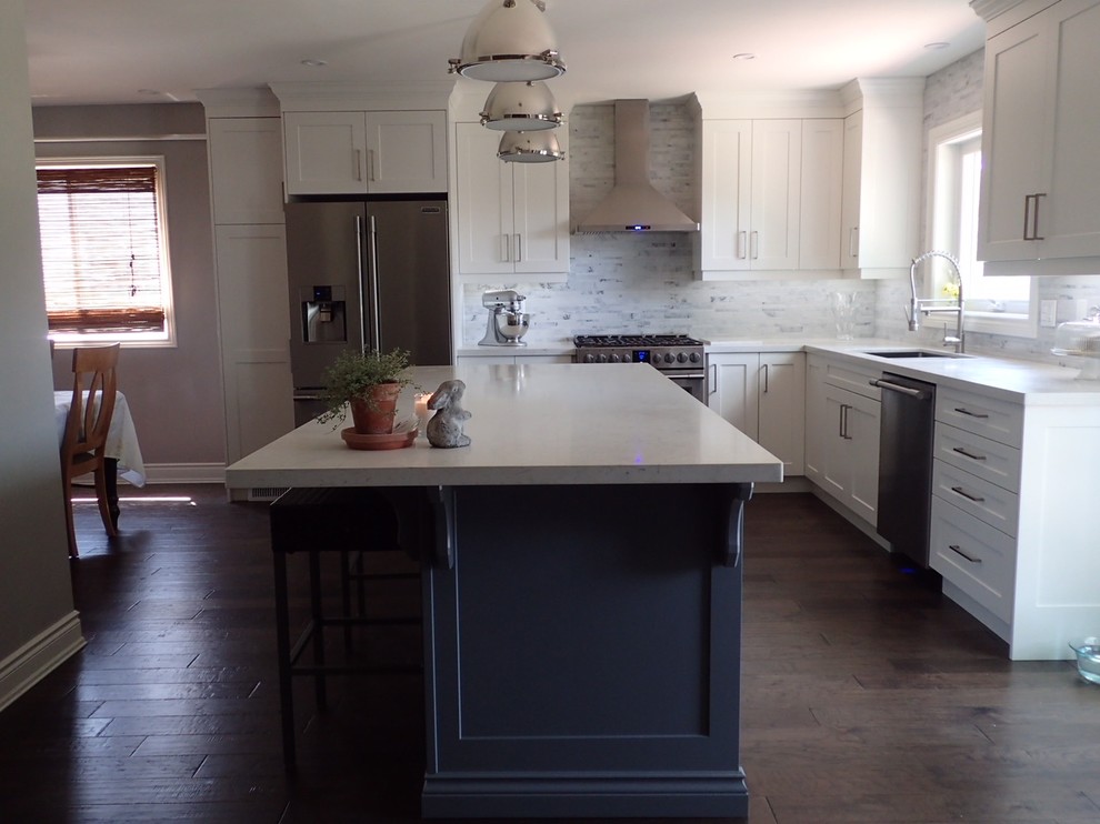 Large transitional l-shaped kitchen photo in Toronto with shaker cabinets, white cabinets, stainless steel appliances and an island