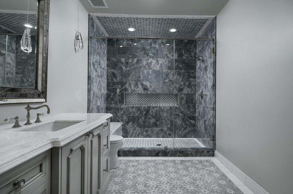 Mid-sized minimalist marble floor, gray floor and single-sink bathroom photo in Phoenix with black cabinets, white walls, a drop-in sink, marble countertops, a hinged shower door, white countertops and a built-in vanity