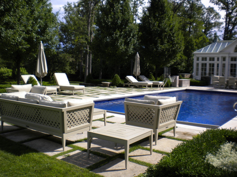 Design ideas for a traditional rectangular lap pool in Chicago with natural stone pavers.