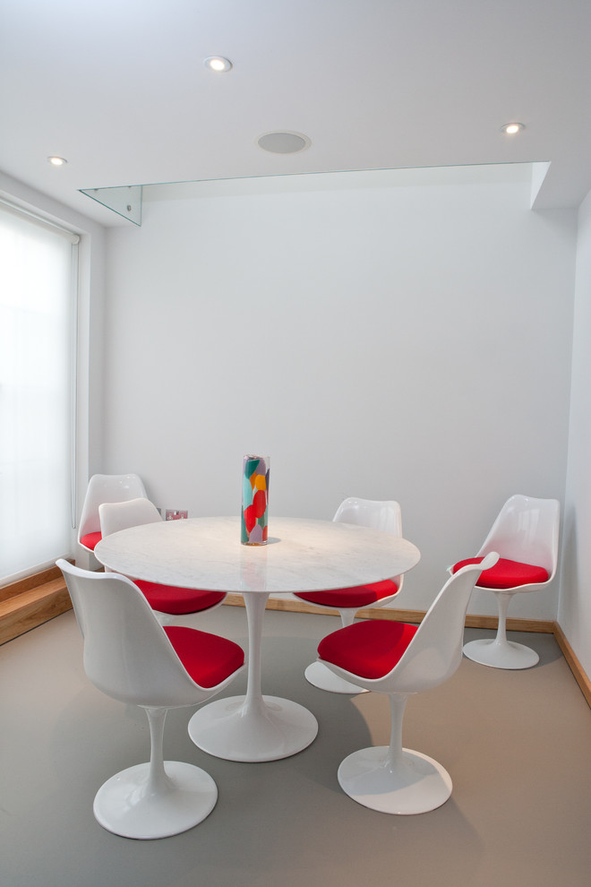 Photo of a modern dining room in London with white walls.