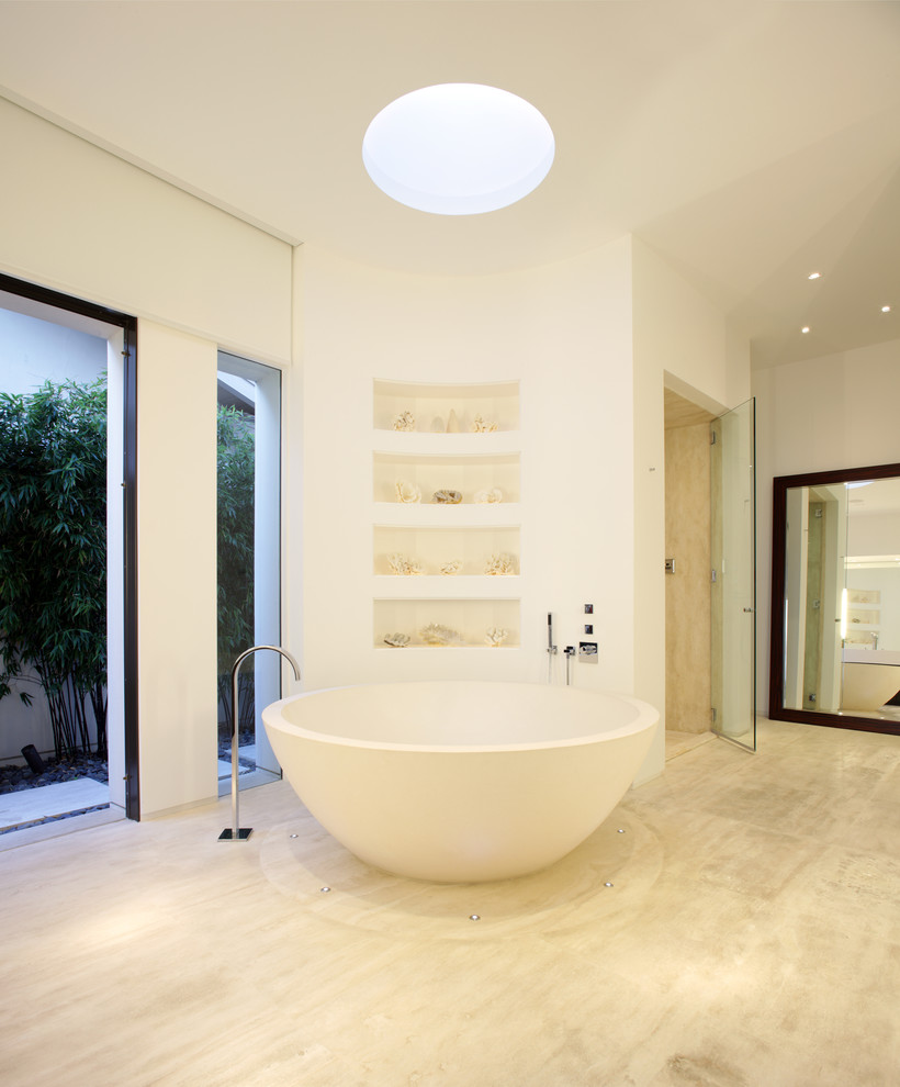 Photo of a large contemporary master bathroom in Orange County with a freestanding tub, an alcove shower, a hinged shower door, a one-piece toilet, white walls, porcelain floors, a wall-mount sink, solid surface benchtops and beige floor.