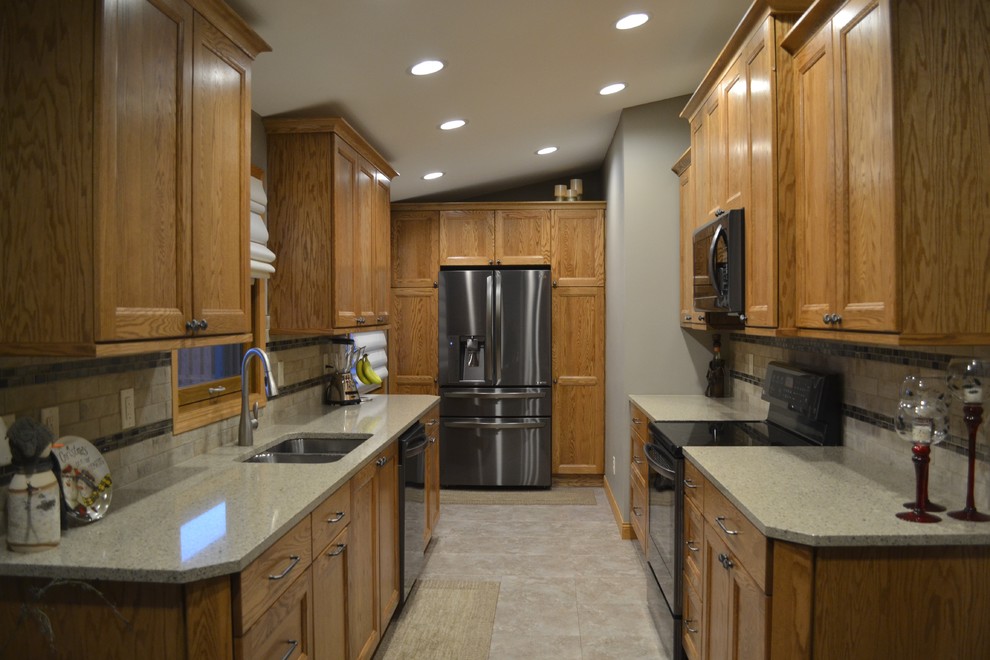 Eat-in kitchen - mid-sized transitional galley eat-in kitchen idea with an undermount sink, flat-panel cabinets, medium tone wood cabinets, quartz countertops, beige backsplash, porcelain backsplash, stainless steel appliances and no island