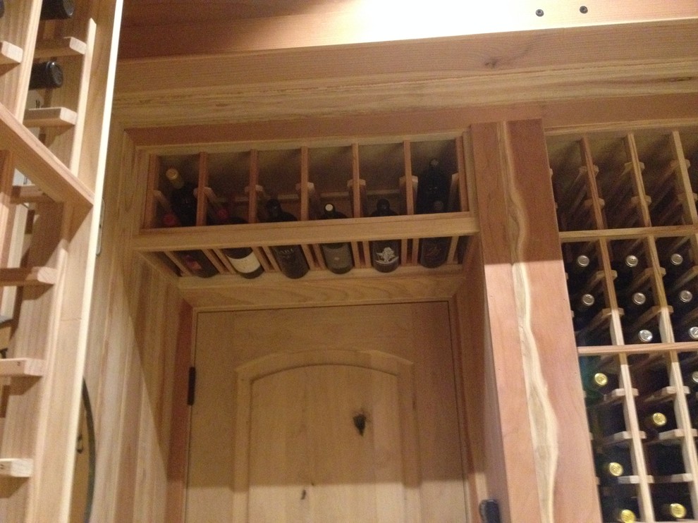 This is an example of a large traditional wine cellar in San Diego with concrete floors and storage racks.