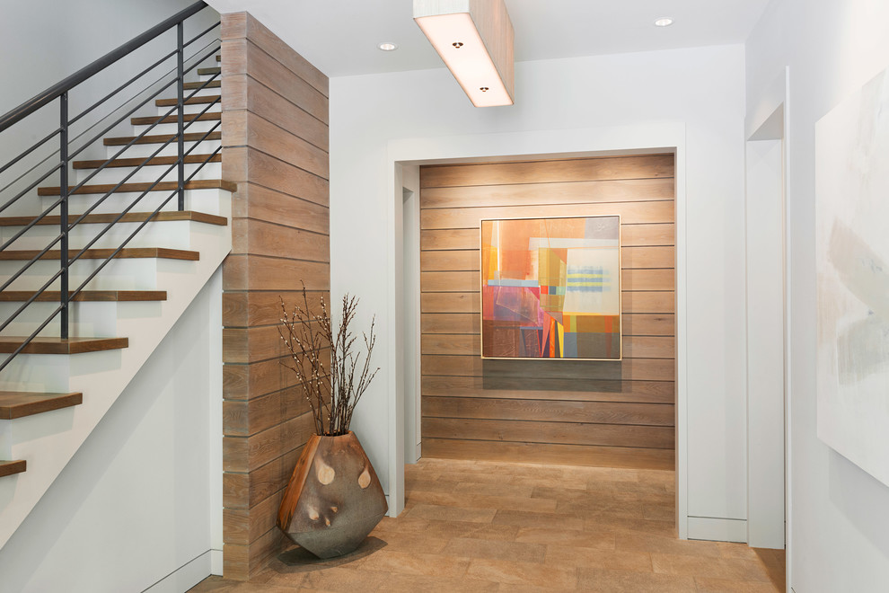 Design ideas for a large modern foyer in Other with white walls, a pivot front door, a dark wood front door and brown floor.