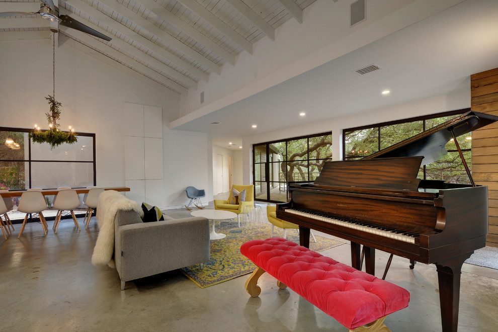 Inspiration for a large eclectic open concept living room in Austin with a music area, white walls, concrete floors, no fireplace and grey floor.