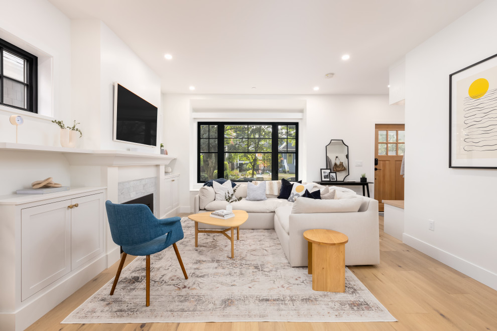 Photo of a modern living room in Vancouver with a standard fireplace.