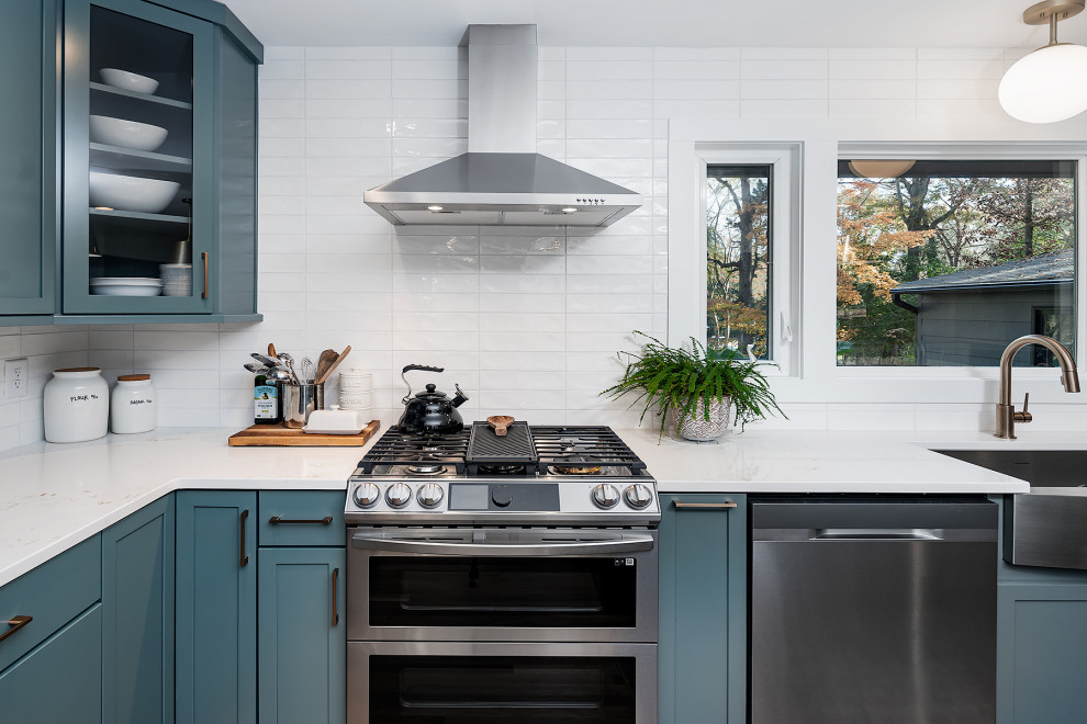 Photo of a large midcentury l-shaped eat-in kitchen in Charlotte with an undermount sink, shaker cabinets, turquoise cabinets, marble benchtops, white splashback, stainless steel appliances and with island.