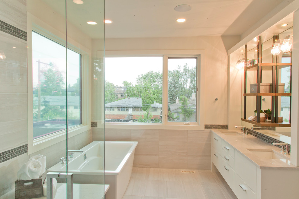 Example of a mid-sized transitional freestanding bathtub design in Calgary with white cabinets
