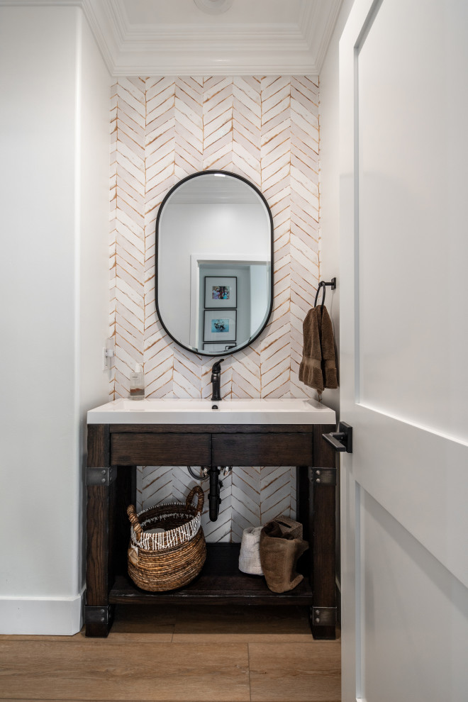 Photo of a small midcentury powder room in San Diego with furniture-like cabinets, distressed cabinets, a one-piece toilet, beige tile, porcelain tile, white walls, laminate floors, terrazzo benchtops, beige floor, brown benchtops and a freestanding vanity.