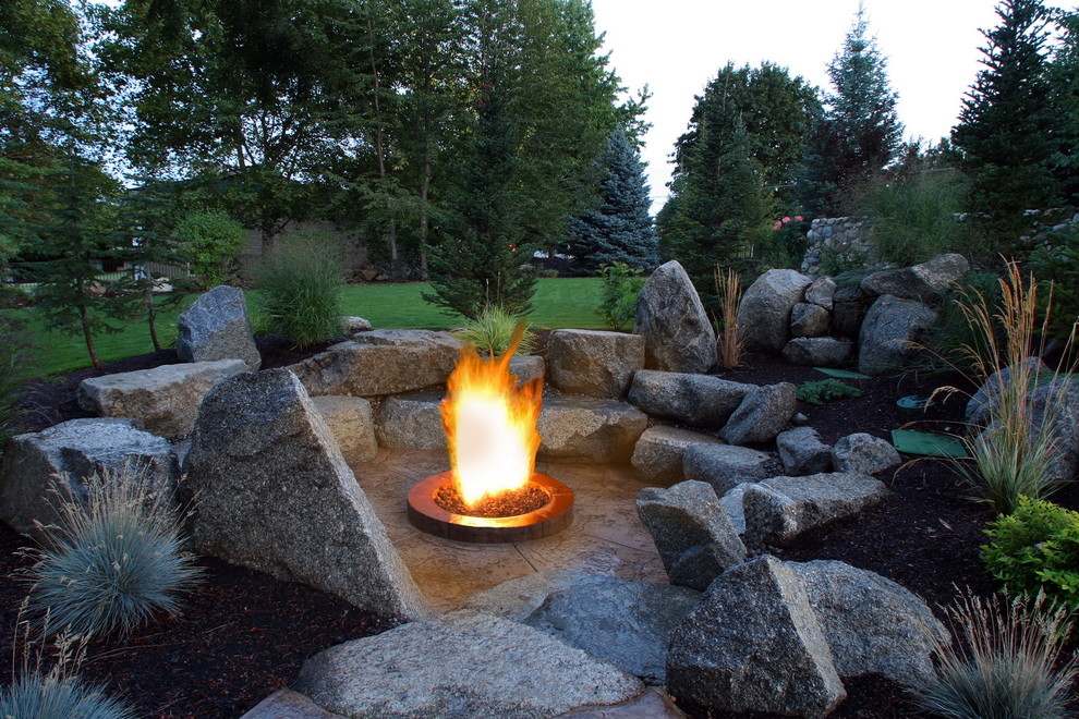 Inspiration for a mid-sized traditional backyard patio in Seattle with a fire feature and natural stone pavers.