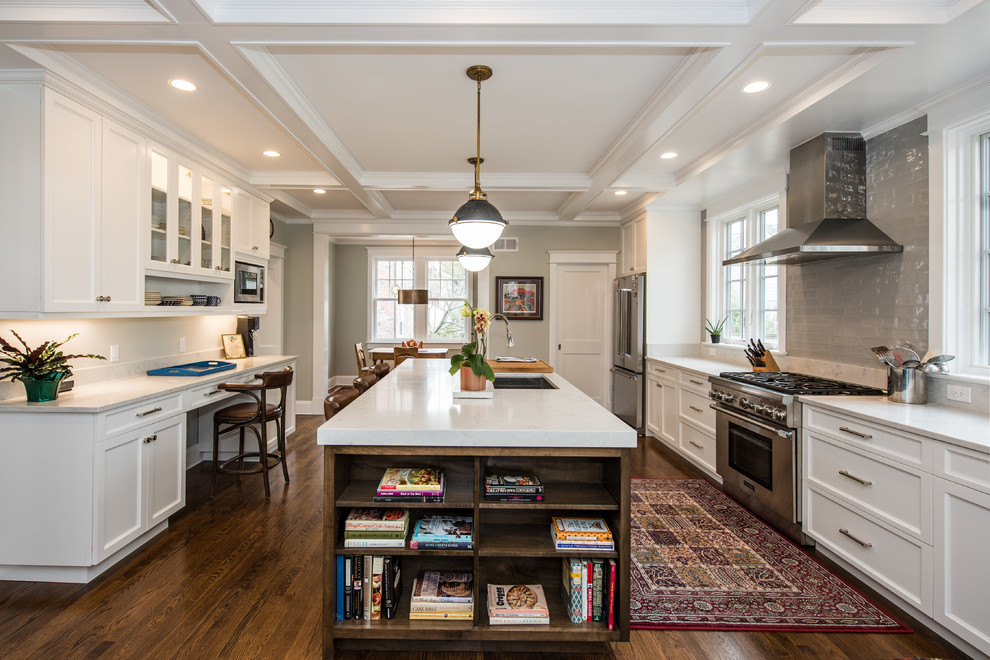 Photo of a large transitional galley open plan kitchen in DC Metro with an undermount sink, recessed-panel cabinets, white cabinets, granite benchtops, grey splashback, subway tile splashback, stainless steel appliances, dark hardwood floors, with island and brown floor.