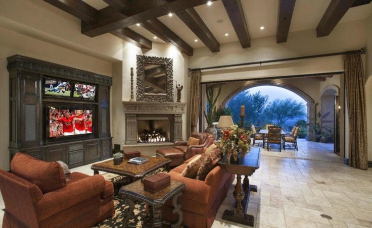 Photo of an expansive traditional open concept living room in Phoenix with beige walls, medium hardwood floors and a wall-mounted tv.