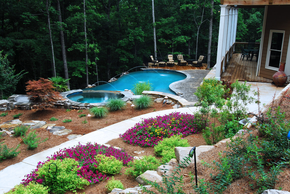 Inspiration for a large rustic backyard kidney-shaped infinity water slide remodel in Atlanta