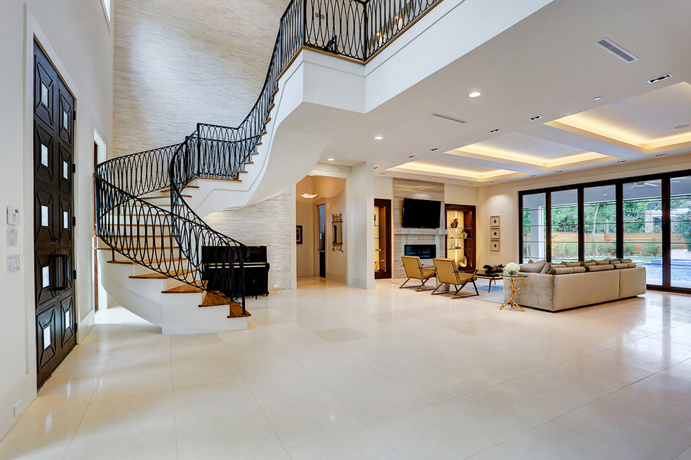 Mid-sized contemporary wood curved staircase in Houston with painted wood risers and metal railing.