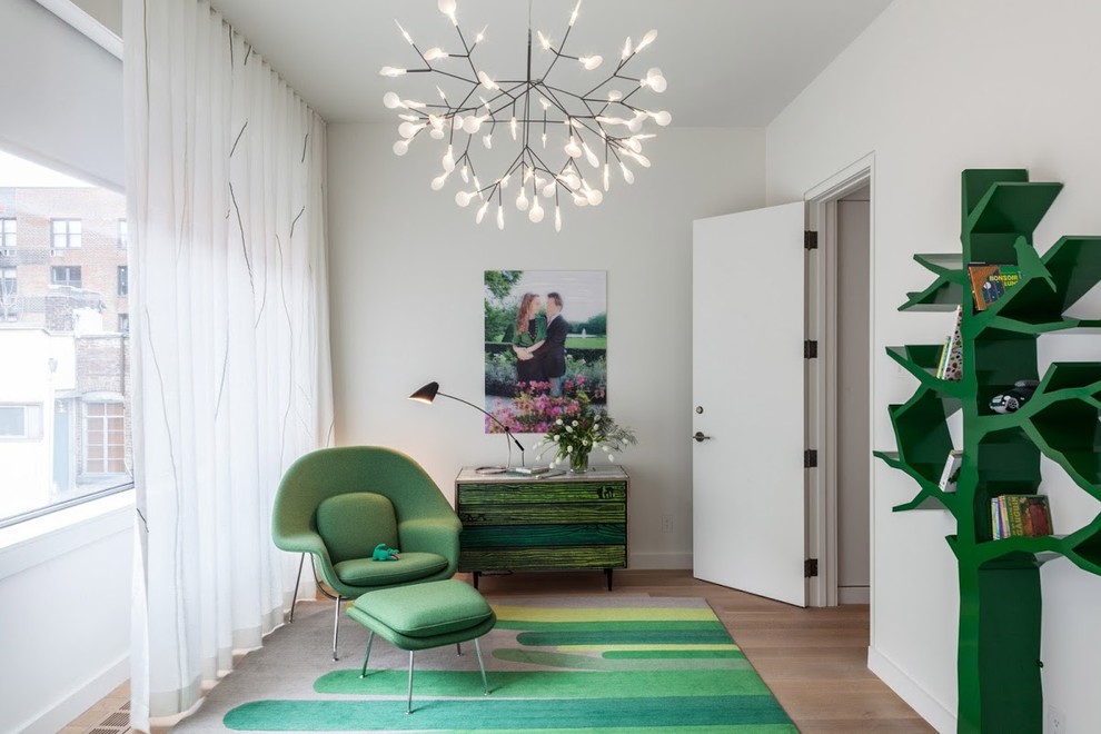 Contemporary gender-neutral kids' playroom in New York with white walls and light hardwood floors.