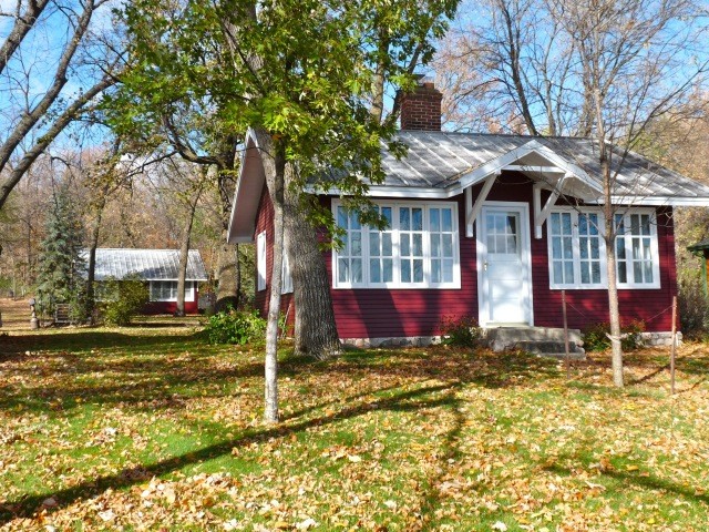 Small arts and crafts one-storey red exterior in DC Metro with wood siding and a gable roof.