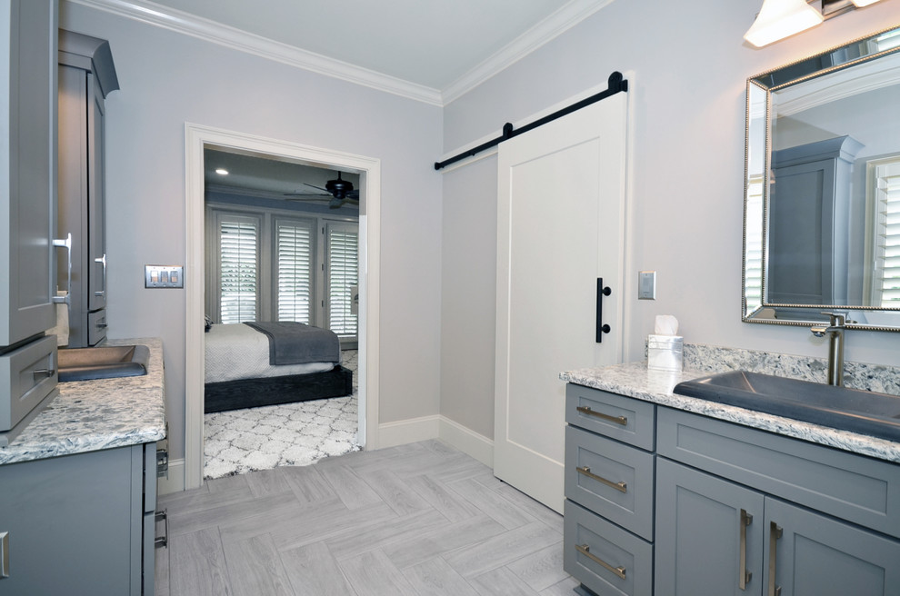 Mid-sized country master bathroom in Charlotte with shaker cabinets, grey cabinets, gray tile, porcelain tile, porcelain floors, a drop-in sink, engineered quartz benchtops, grey floor and grey benchtops.