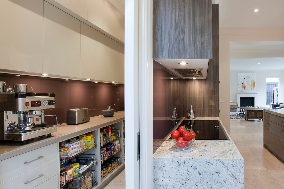 Photo of a large contemporary kitchen pantry in Melbourne with an undermount sink, flat-panel cabinets, medium wood cabinets, granite benchtops, red splashback, glass sheet splashback, stainless steel appliances, porcelain floors and with island.