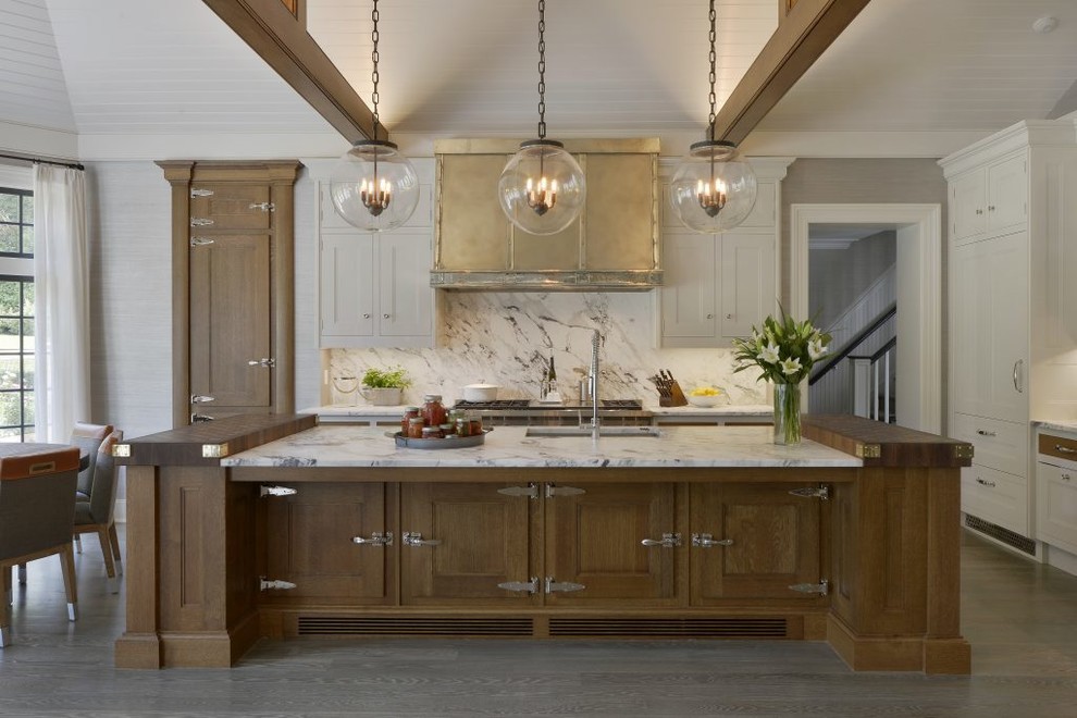 Inspiration for a transitional l-shaped medium tone wood floor and gray floor eat-in kitchen remodel in Dallas with an undermount sink, shaker cabinets, medium tone wood cabinets, white backsplash, paneled appliances, an island and white countertops