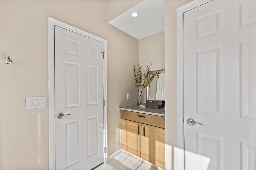 Inspiration for a large transitional master bathroom in DC Metro with flat-panel cabinets, light wood cabinets, a corner shower, a hinged shower door, a double vanity and a built-in vanity.