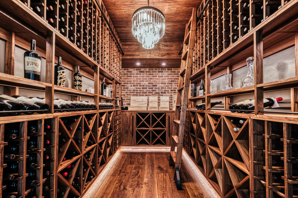 Photo of a mid-sized eclectic wine cellar in Portland with medium hardwood floors, storage racks and brown floor.