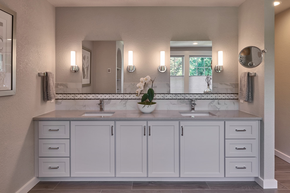 Design ideas for a transitional master bathroom in Seattle with shaker cabinets, white cabinets, marble, grey walls and an undermount sink.