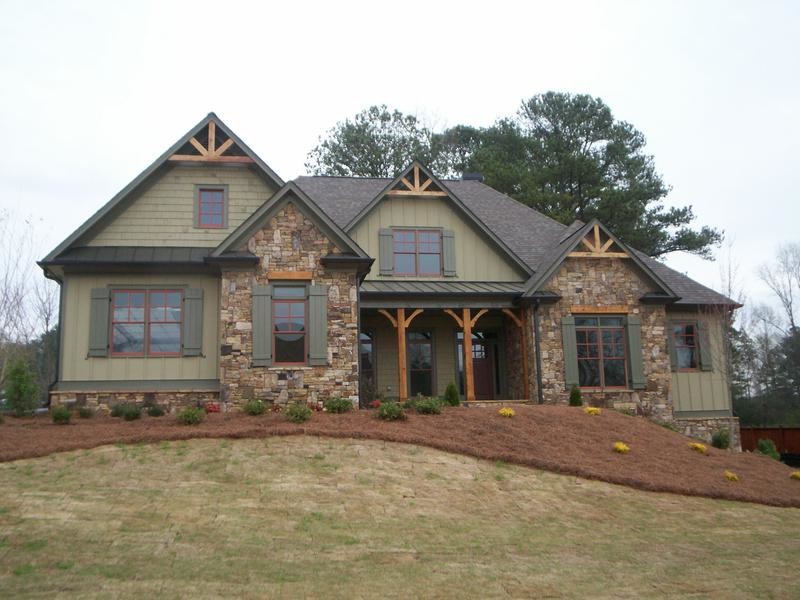 Inspiration for a large traditional two-storey green house exterior in Atlanta with wood siding, a gable roof and a shingle roof.